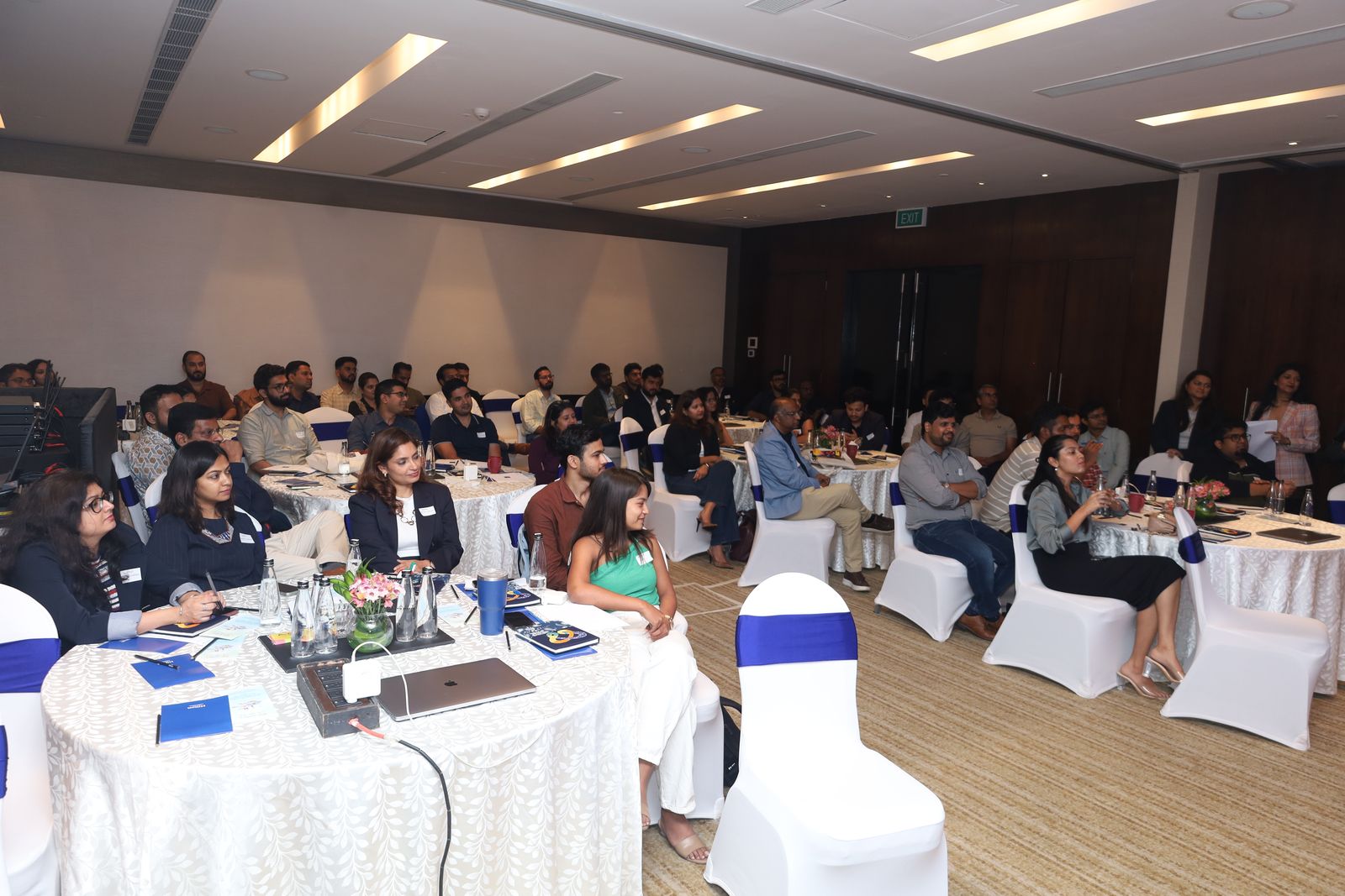The full room at round tables during the Bengaluru session