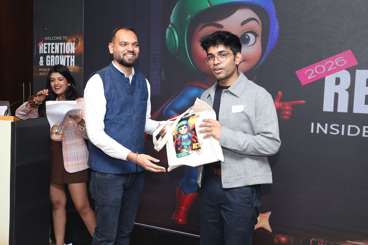 An attendee receiving an aiRA tote on stage