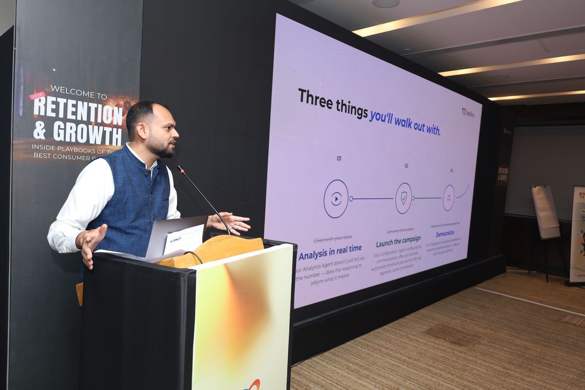 A speaker presenting the session's three takeaways on screen