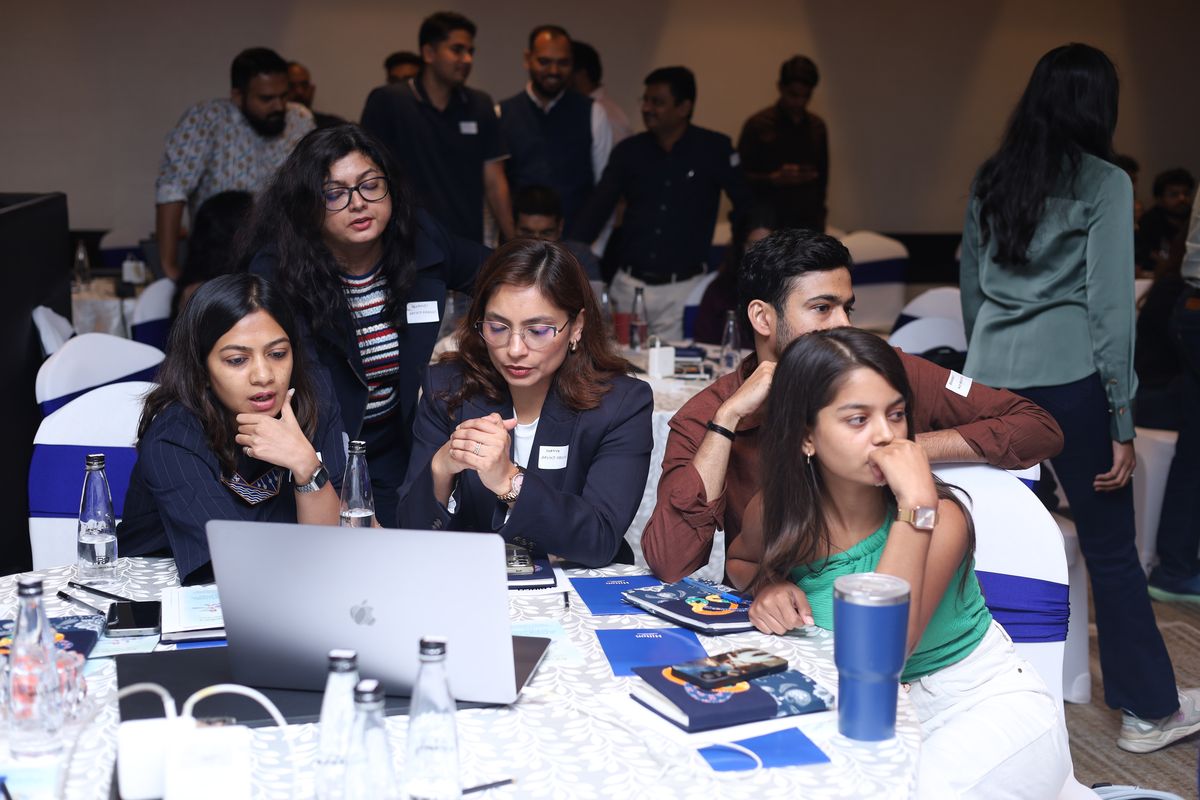 A table of attendees following along on a laptop
