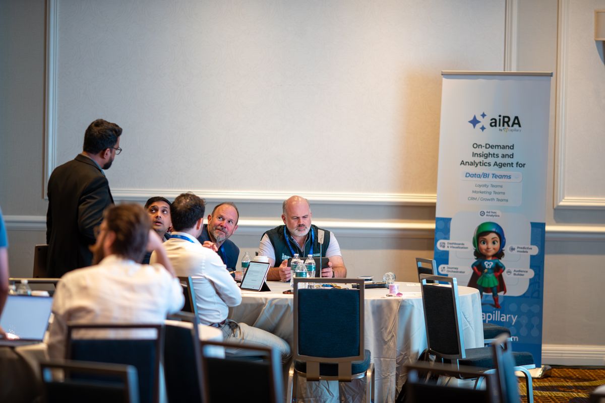 A small round-table session beside an aiRA banner